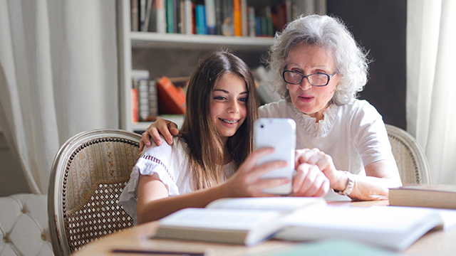 Grandmother and granddaughter using aged care technology